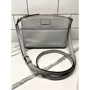 Light gray Kate Spade cross body, front pocket, adjustable strap